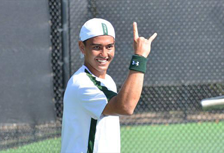 Yannick smiles and holds up a "go bulls" sign