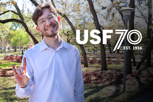 Matheus Ivanesciuc smiling and holding up go bulls sign with hands