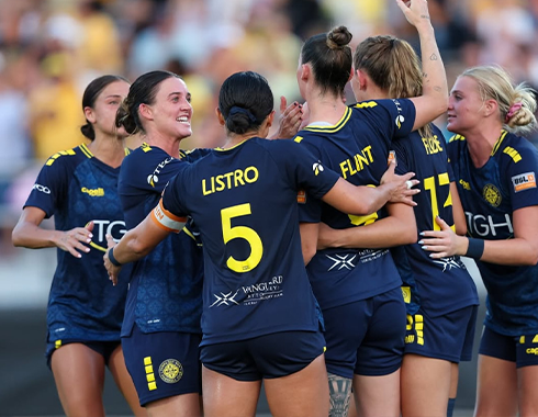 Listro celebrating with team mates in soccer jerseys