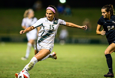 Listro kicking a soccer ball in USF jersey