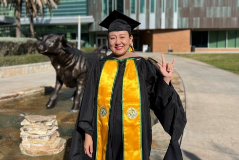 Lujuan outside the Marshall Student Center after graduating
