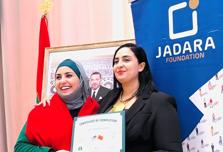 Two people smiling and holding a certificate