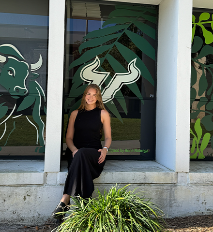 Nobrega standing in front of the decals she put up
