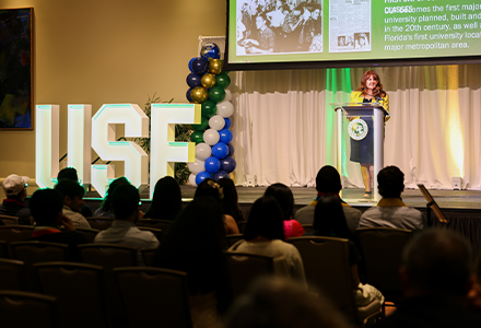 Marcia speaking to room full of international students and their families