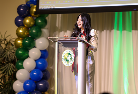 Bui speaking to room full of international students and their families